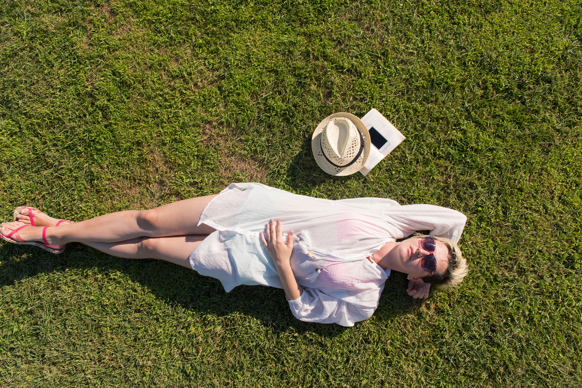 Top view of a woman lying on a bed, appearing relaxed and thoughtful, symbolizing self-reflection or mental well-being.